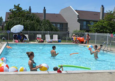 Anderson Communities Park Hill outdoor pool with people playing in it